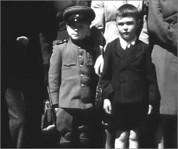 Two boys, Soviet and British, watch marching soldiers at the Allied parade, Berlin, May 8, 1946 - The photo, Black and white photo, Film, Germany, Berlin, The Great Patriotic War, Old photo, May 9 - Victory Day, 1946