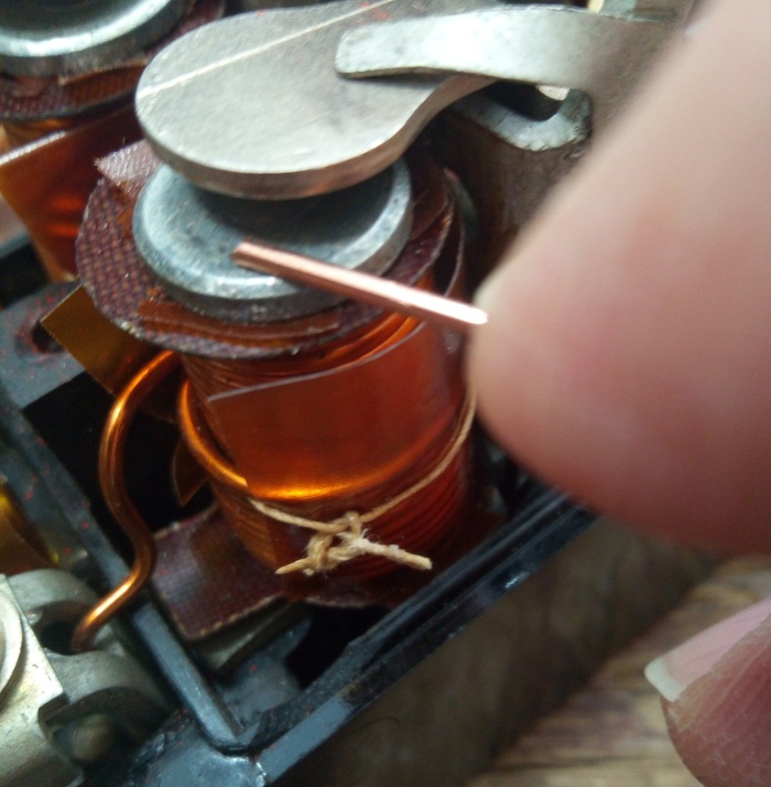 Проволочкой указан сердечник-цилиндр, вокруг которого, через изоляцию конечно, намотана катушка реле.